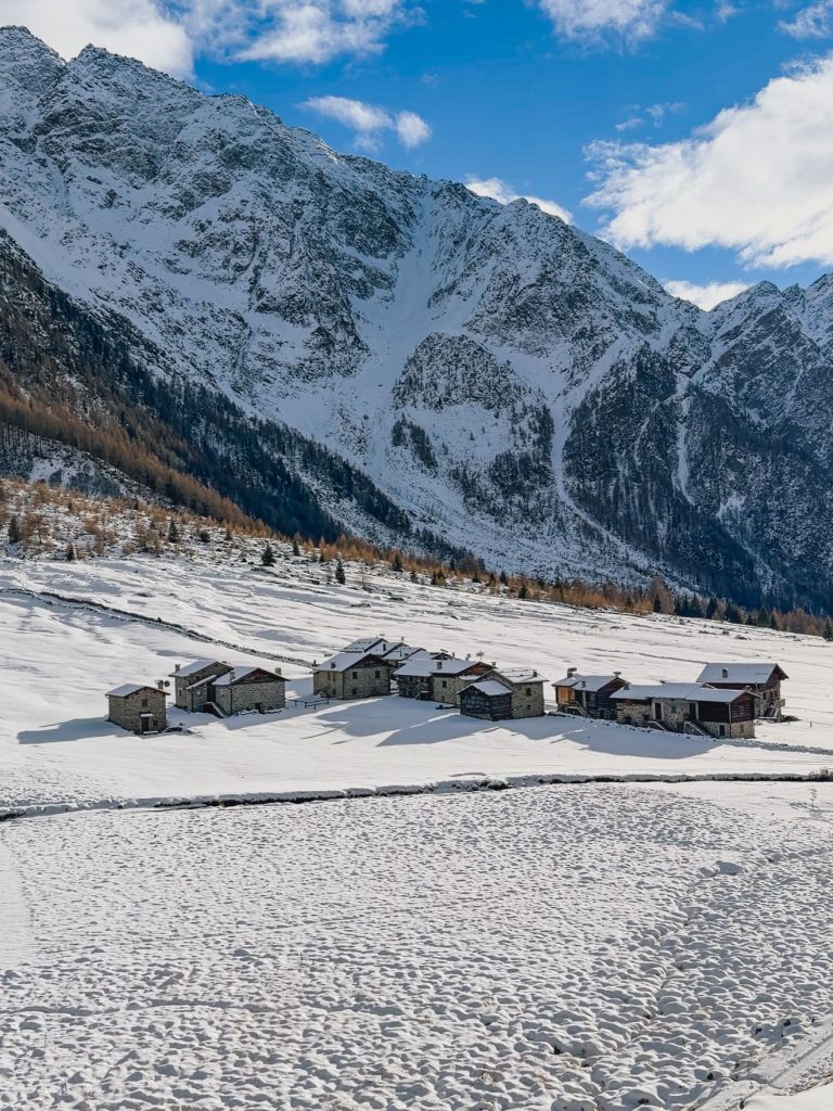Case tipiche in pietra e legno circondate dalla neve in Val di Rezzalo