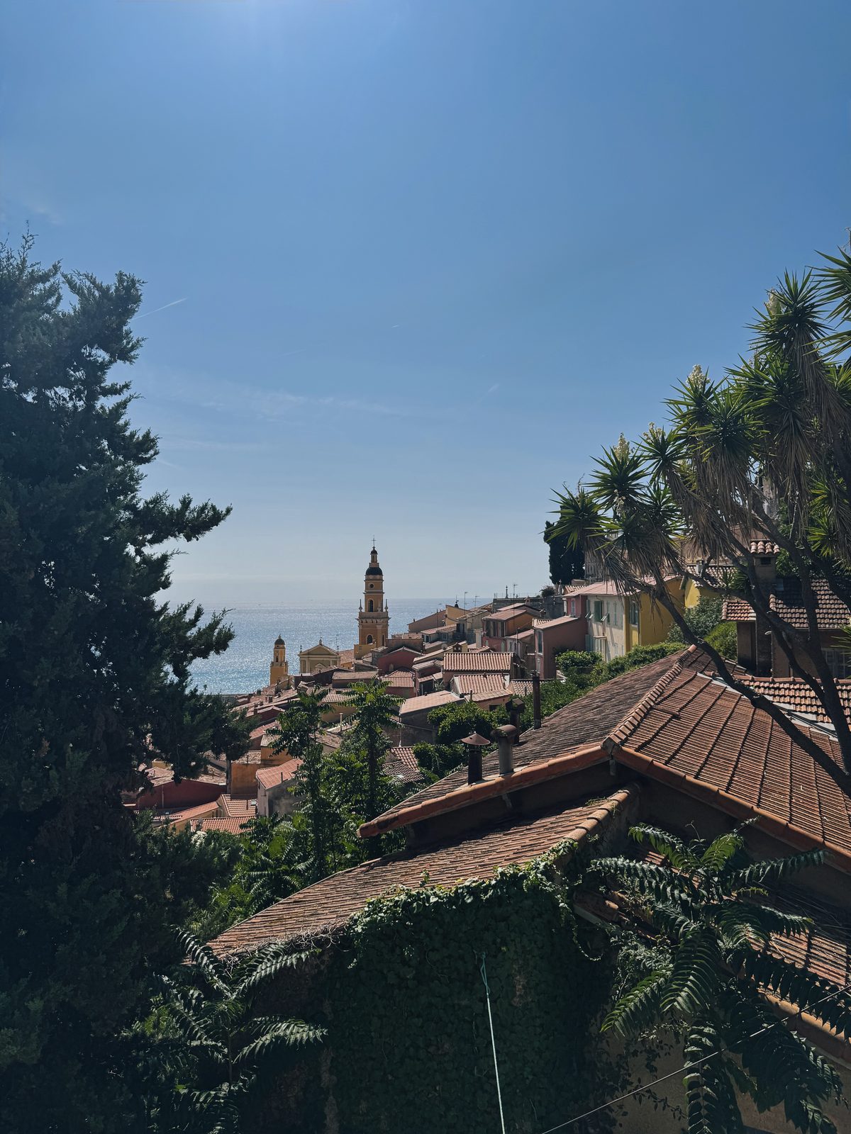 Vista sui tetti del centro storico di Mentone con il campanile della basilica e il mare sullo sfondo